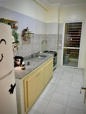 a kitchen with a sink and a stove top oven at Cosy appartement near to airport in Marrakech