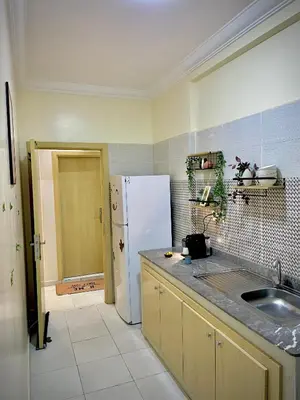 a kitchen with a sink and a refrigerator at Cosy appartement near to airport in Marrakech