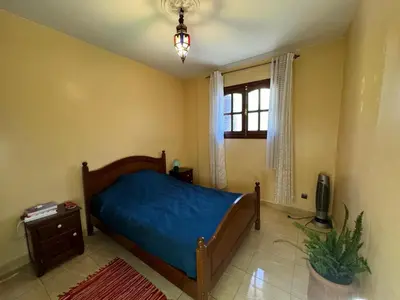 a bedroom with a blue bed and a window at Cozy room in marrakech in Marrakech