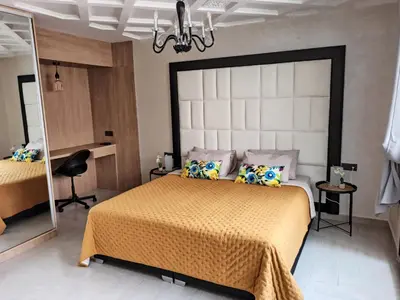 a bedroom with a large bed and a mirror at Splendid One Bedroom center of Marrakech -Gueliz- in Marrakech