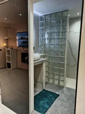 a bathroom with a sink and a glass wall at Splendid One Bedroom center of Marrakech -Gueliz- in Marrakech