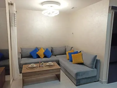 a living room with a blue couch and a table at Splendid One Bedroom center of Marrakech -Gueliz- in Marrakech