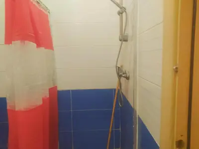 a bathroom with a shower with blue and red tiles at Apartment Targa Reserved for Families in Marrakech