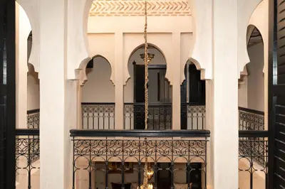 a balcony of a building with a chandelier at Villa riad raffinée privée à Marrakech in Marrakech