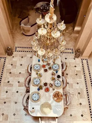 a table with many plates of food on it at Villa riad raffinée privée à Marrakech in Marrakech