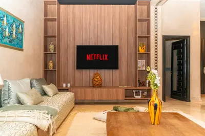 a living room with a tv on a wall at Villa riad raffinée privée à Marrakech in Marrakech
