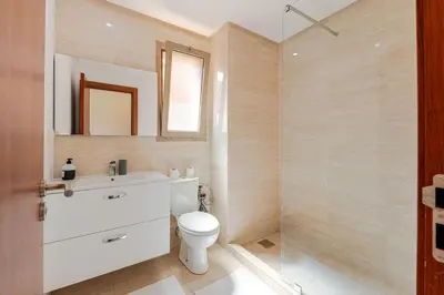 a bathroom with a toilet and a sink and a shower at Luxury Appartement Golf and Pool in Marrakech