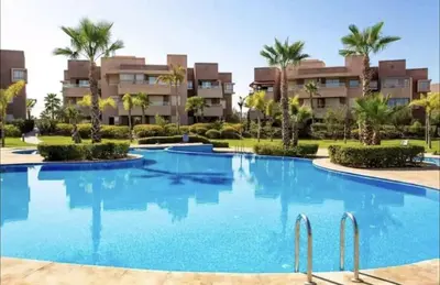 a swimming pool in front of a resort at Luxury Appartement Golf and Pool in Marrakech