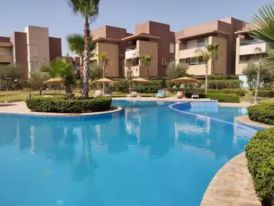 a large swimming pool in front of a building at Luxury Appartement Golf and Pool in Marrakech
