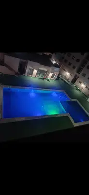 a view of a swimming pool at night at BIG comfort with pool North Gueliz RIAD Ambiance in Marrakech