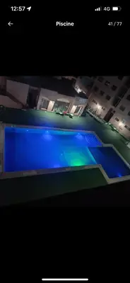 a view of a swimming pool at night at BIG comfort with pool North Gueliz RIAD Ambiance in Marrakech