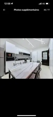 a picture of a kitchen with a long table at BIG comfort with pool North Gueliz RIAD Ambiance in Marrakech