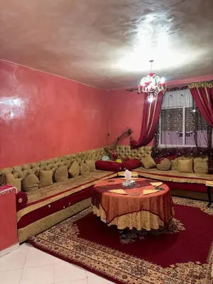 a living room with a couch and a table at 2 bedroom apartment with Moroccan living room in Allal El Fassi in Marrakech