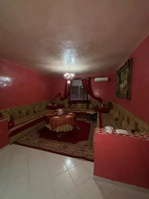 a living room with a table and a couch at 2 bedroom apartment with Moroccan living room in Allal El Fassi in Marrakech