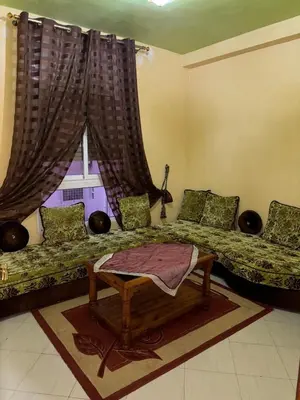 a living room with two beds and a window at 2 bedroom apartment with Moroccan living room in Allal El Fassi in Marrakech