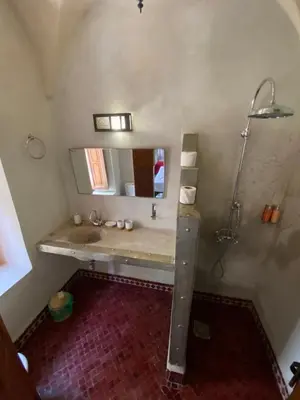 a bathroom with a sink and a shower at Riad Bab Yacout & SPA in Marrakech