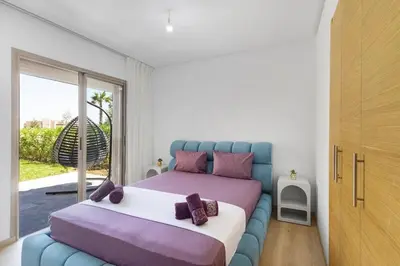 a bedroom with a bed and a large window at Nice apartment in Marrakesh in Marrakech