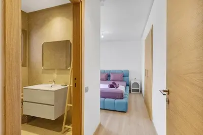 a bedroom with a blue bed and a sink and a bathroom at Nice apartment in Marrakesh in Marrakech