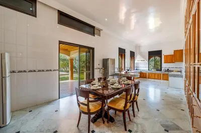 a kitchen with a table and chairs in a room at Taj Palmeraie Palace Marrakech in Marrakech