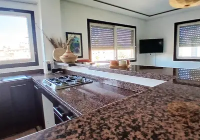 a kitchen with a stove and a counter top at Séjour Arty et Confort à Marrakech in Marrakech