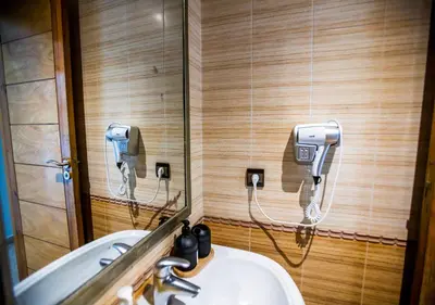 a bathroom with a sink and a phone on the wall at Séjour Arty et Confort à Marrakech in Marrakech