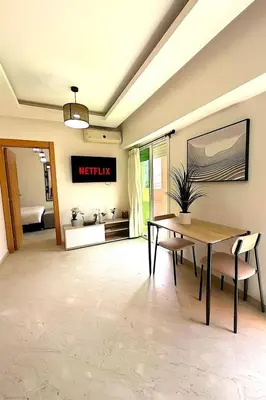 a dining room with a table and a sign on the wall at Pause rêvée au cœur de Marrakech in Marrakech