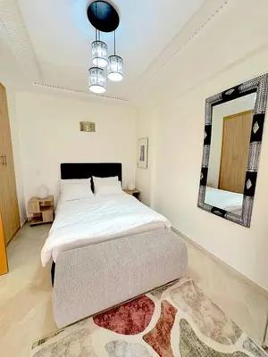 a bedroom with a large bed and a mirror at Pause rêvée au cœur de Marrakech in Marrakech