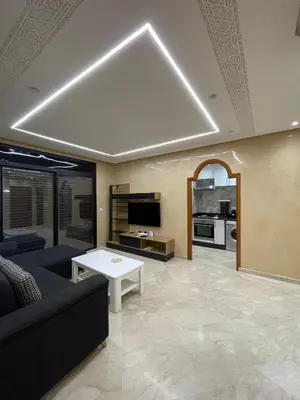 a living room with a couch and a table at Appartement Centre Ville Gueliz Parking Inclus in Marrakech