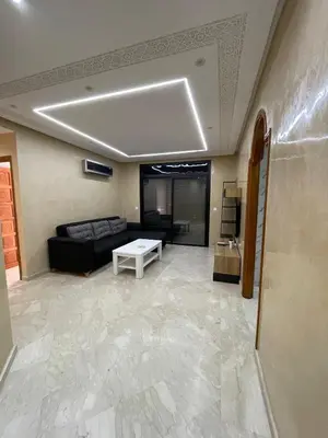 a living room with a couch and a table at Appartement Centre Ville Gueliz Parking Inclus in Marrakech
