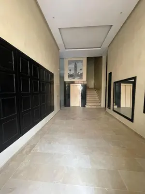 a room with a hallway with black doors and a tile floor at Appartement Centre Ville Gueliz Parking Inclus in Marrakech