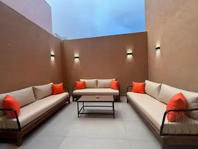 a waiting area with couches and a table in a room at Elegant Duplex 2 chambres in Marrakech