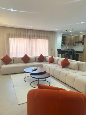 a large living room with a couch and a table at Elegant Duplex 2 chambres in Marrakech