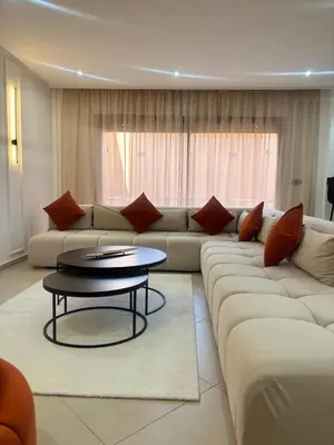 a living room with a couch and a table at Elegant Duplex 2 chambres in Marrakech