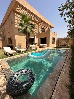 a swimming pool with a tire in the water at Villa familiale a 10km du boulevard Mohamed VI in Marrakech