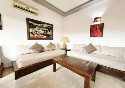 a living room with two couches and a coffee table at Escapade citadine avec balcon et confort total in Marrakech