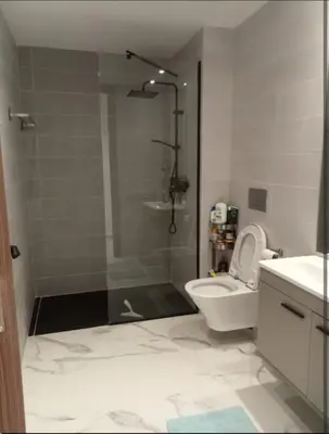 a bathroom with a shower and a toilet and a sink at Appartement cosy moderne luxe in Marrakech