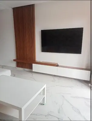 a living room with a flat screen tv on a wall at Appartement cosy moderne luxe in Marrakech