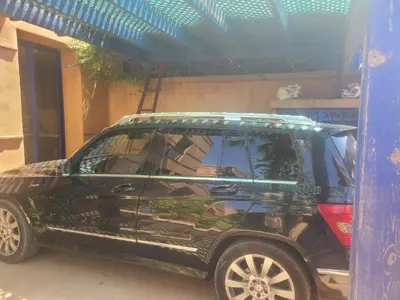 a black suv with a surfboard on top of it at Villa Marrakech haut standing avec piscine et architecture arabesque in Marrakech
