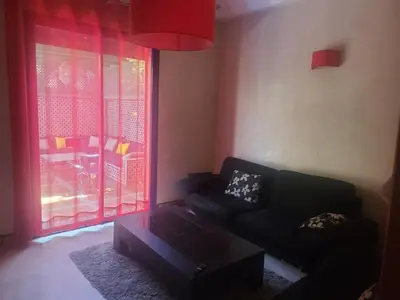 a living room with a couch and a coffee table at Villa Marrakech haut standing avec piscine et architecture arabesque in Marrakech