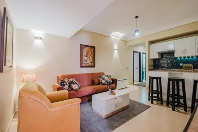 a living room with a couch and a table at Appartement Relax & Confort au Cœur de Marrakech in Marrakech