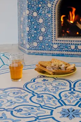 a table with a plate of bread and a glass of beer at Very comfortable villa in the heart of Marrakech in Marrakech