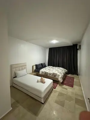 a bedroom with two beds and a window at L'AUTHENTIQUE 37 face de la gare CTM Hivernage in Marrakech