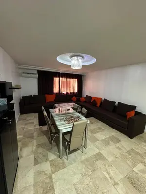 a living room with a couch and a table at L'AUTHENTIQUE 37 face de la gare CTM Hivernage in Marrakech