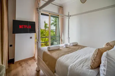 a bedroom with a bed with a sign that reads notify at M REVASION villa 5 chambres front de golf Petit déjeuner petit ménage et Tranfert aéroport inclus in Marrakech
