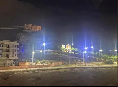 a city at night with street lights and a building at Moroccorent in Marrakech