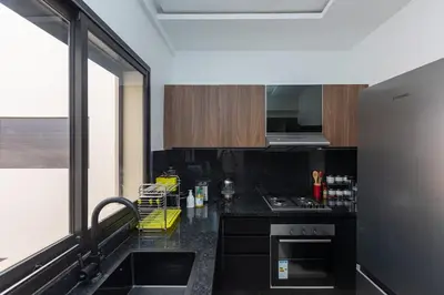 a kitchen with black counter tops and a large window at Elegance and Comfort in Marrakesh in Marrakech
