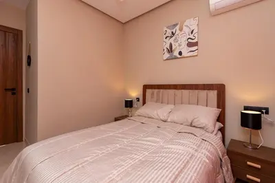 a bedroom with a large bed and two lamps at Elegance and Comfort in Marrakesh in Marrakech