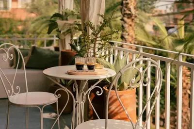 two glasses of wine on a table on a balcony at Cozy apartment Marrakech hivernage with nice terrace in Marrakech