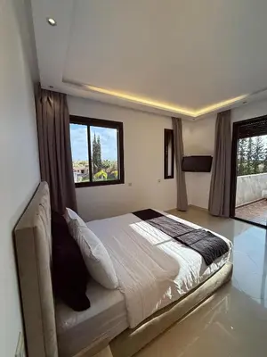 a bedroom with a large bed and a window at Villa privée in Marrakech