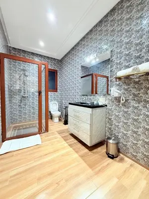 a bathroom with a shower and a sink and a toilet at Villa privée in Marrakech